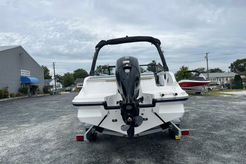 Slide: The Image of 2026 Bayliner V20 boat on trailer, rear view, parked outdoors under cloudy sky. - 5