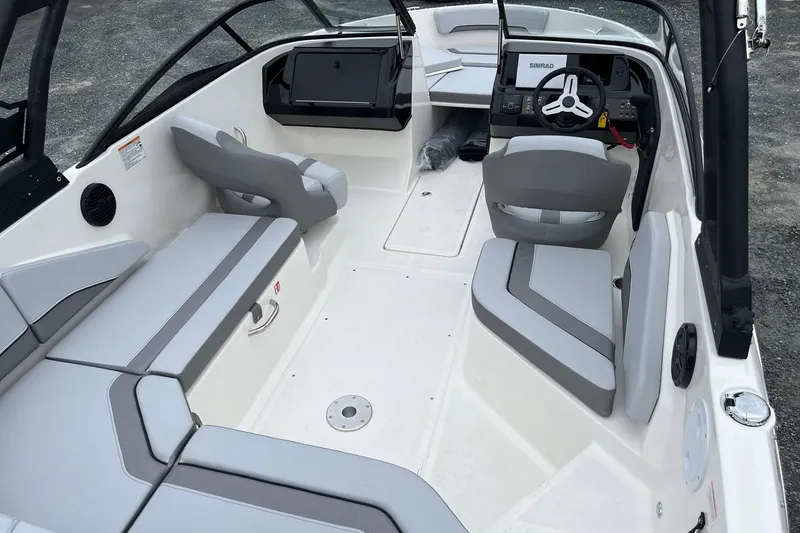 Slide: The Image of 2026 Bayliner V20 boat interior with gray seating and modern dashboard. - 7