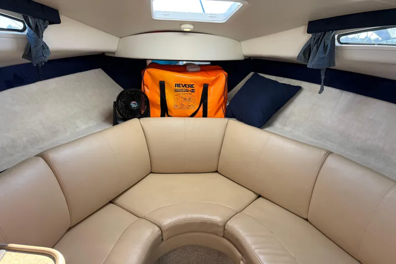 Slide: The Image of Interior of 2006 Bayliner 245 Cruiser with beige seating and safety equipment. - 12