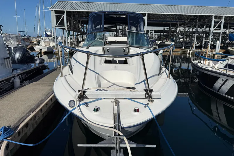 Slide: The Image of 2006 Bayliner 245 Cruiser docked at marina, front view. - 2