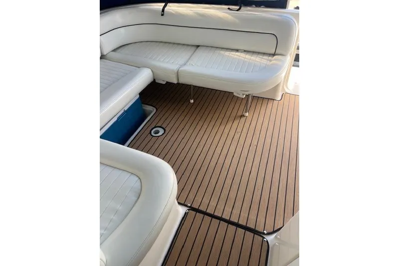 Slide: The Image of 1999 Bayliner 3055 Ciera Sunbridge interior with white seating and wood-style flooring. - 11