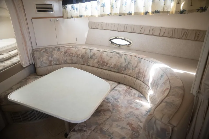 Slide: The Image of 1999 Bayliner 3055 Ciera Sunbridge interior with curved seating and table. - 19