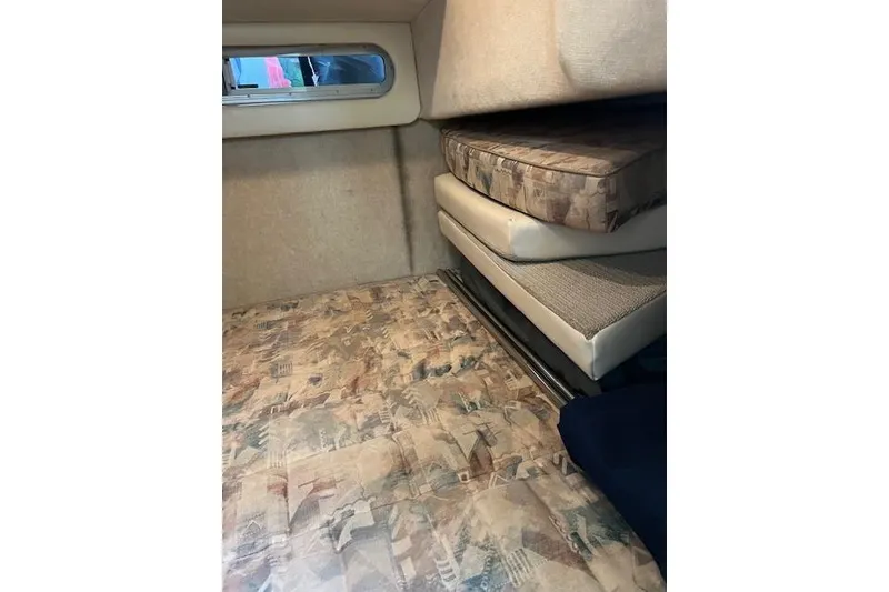 Slide: The Image of Interior cabin of 1999 Bayliner 3055 Ciera Sunbridge with patterned cushions and window. - 20