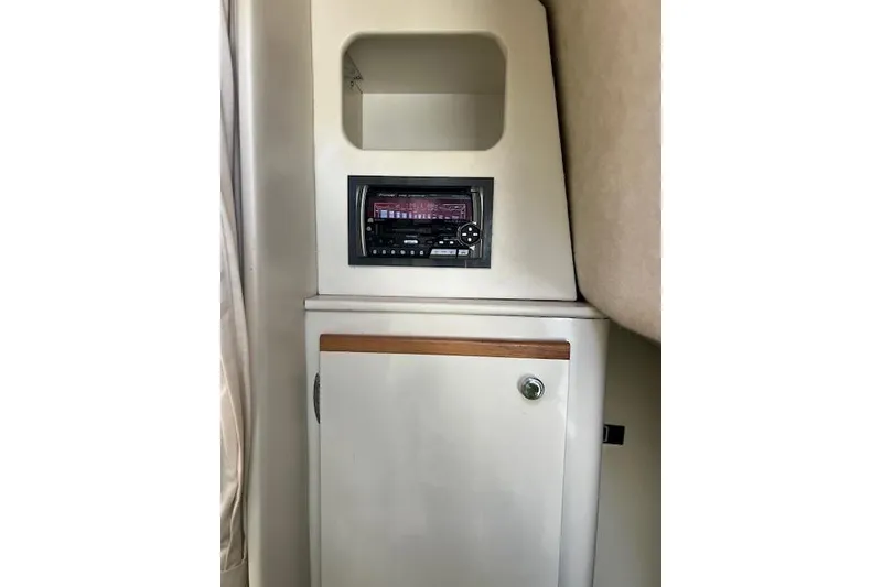 Slide: The Image of 1999 Bayliner 3055 Ciera Sunbridge interior with stereo system and storage cabinet. - 25