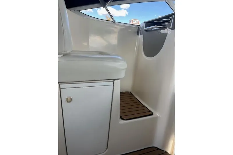 Slide: The Image of 1999 Bayliner 3055 Ciera Sunbridge interior with white seating and wooden steps. - 29