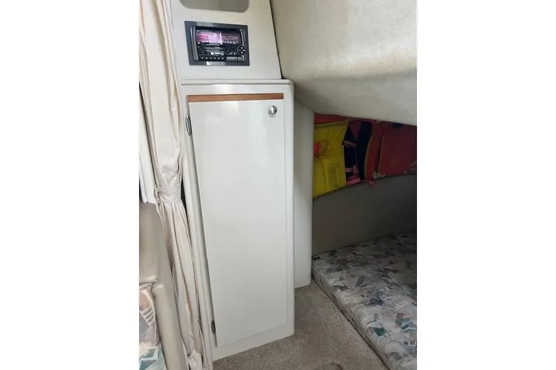 Slide: The Image of Interior of 1999 Bayliner 3055 Ciera Sunbridge with cabinet and stereo system. - 30