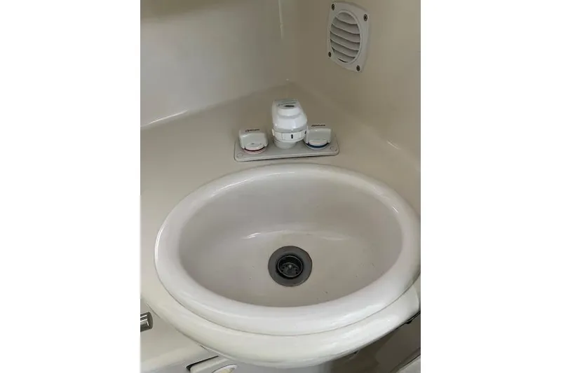 Slide: The Image of 1999 Bayliner 3055 Ciera Sunbridge bathroom sink with faucet and vent. - 32