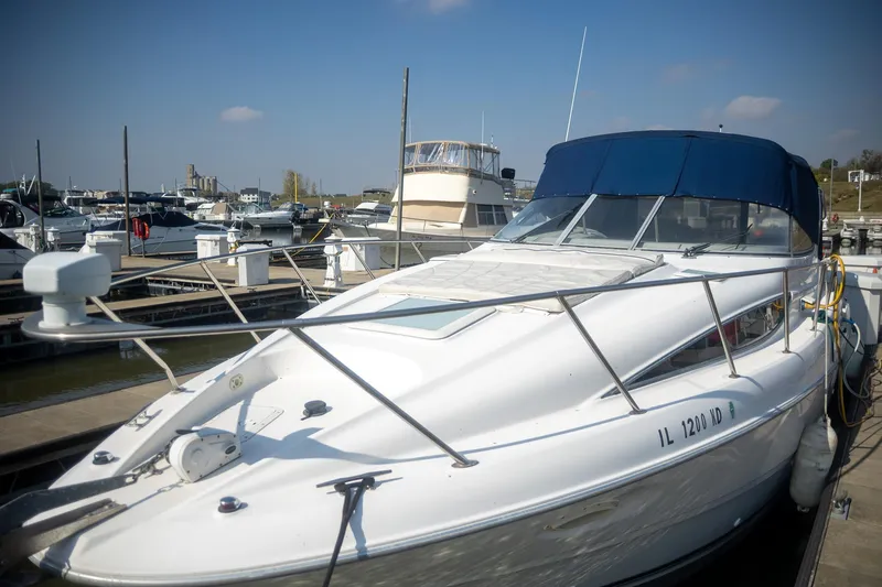 Slide: The Image of 1999 Bayliner 3055 Ciera Sunbridge docked at marina under clear blue sky. - 38