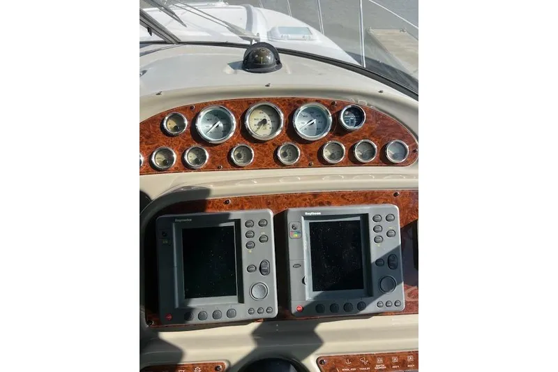 Slide: The Image of 1999 Bayliner 3055 Ciera Sunbridge dashboard with gauges and navigation equipment. - 41