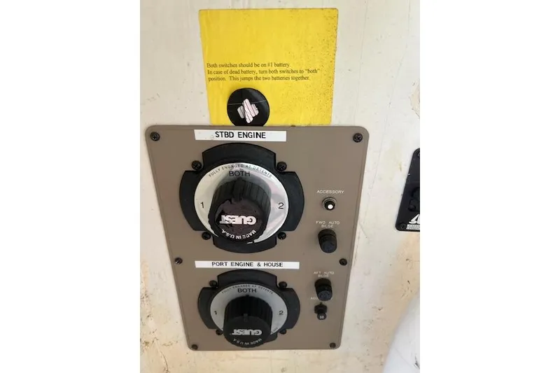 Slide: The Image of Control panel of a 1999 Bayliner 3055 Ciera Sunbridge boat with engine switches. - 43