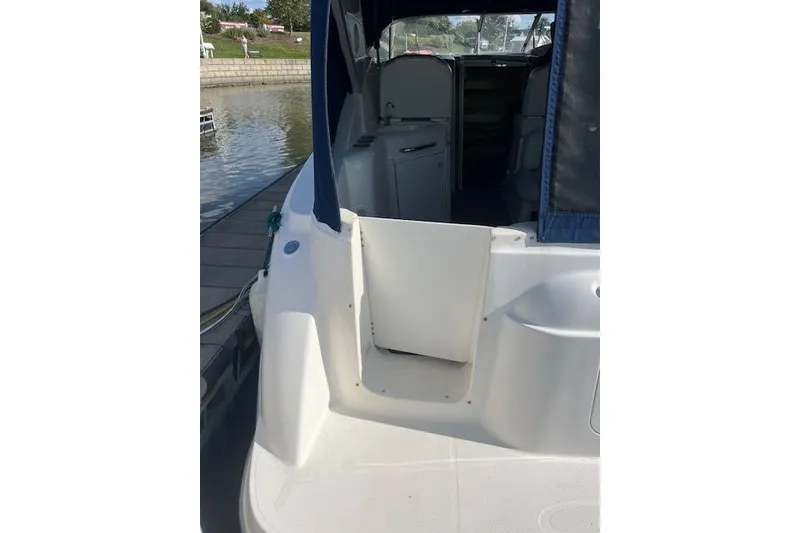 Slide: The Image of 1999 Bayliner 3055 Ciera Sunbridge docked, showing open cabin entrance and interior view. - 44