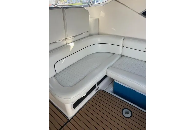 Slide: The Image of 1999 Bayliner 3055 Ciera Sunbridge interior with white seating and wood flooring. - 5