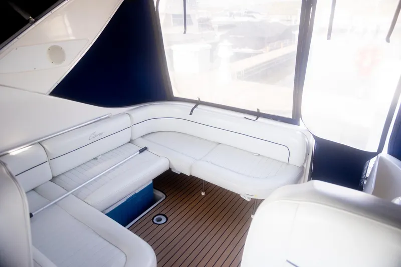 Slide: The Image of 1999 Bayliner 3055 Ciera Sunbridge interior with white seating and wooden flooring. - 9