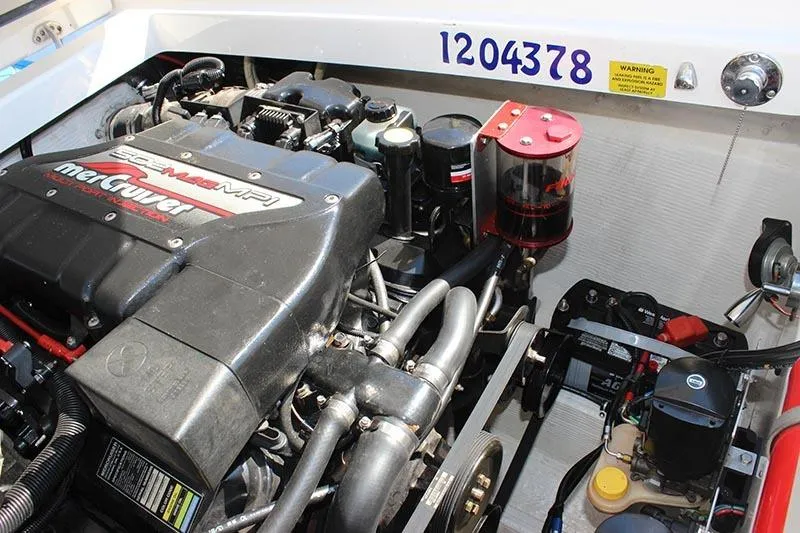 Slide: The Image of Engine compartment of a 2000 Fountain 32 Fever boat, featuring a MerCruiser engine. - 12