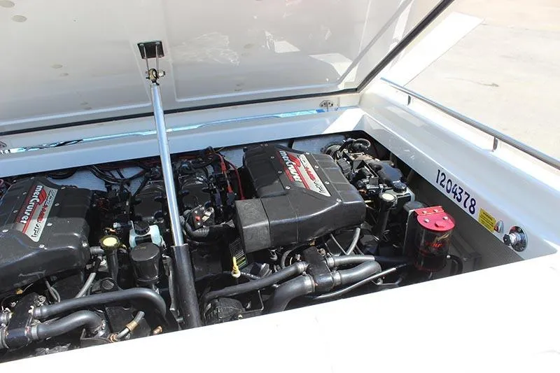 Slide: The Image of Engine compartment of a 2000 Fountain 32 Fever boat, showcasing dual Mercury engines. - 13