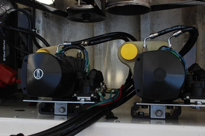 Slide: The Image of Engine components of a 2000 Fountain 32 Fever boat, featuring hydraulic systems and wiring. - 14