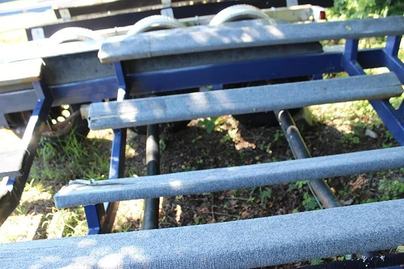 Slide: The Image of Trailer for 2000 Fountain 32 Fever boat, showing blue frame and padded supports. - 26