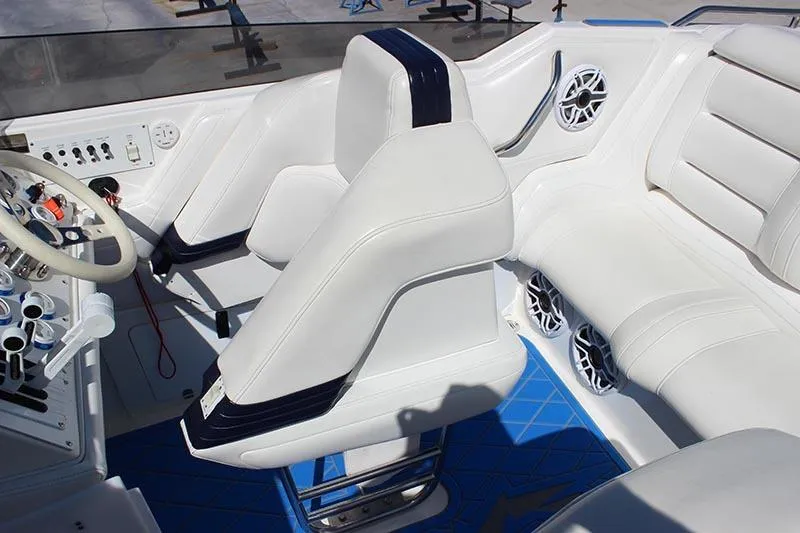 Slide: The Image of Interior of a 2000 Fountain 32 Fever boat with white seating and blue accents. - 27