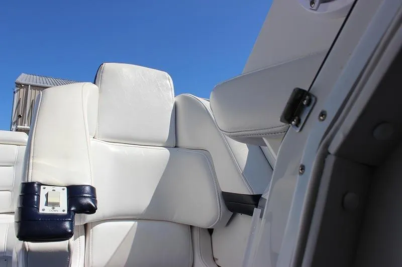 Slide: The Image of White leather seating on a 2000 Fountain 32 Fever boat under clear blue sky. - 28