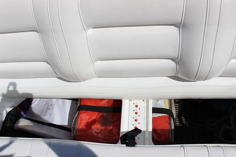 Slide: The Image of White leather seating with storage compartment in 2000 Fountain 32 Fever boat. - 31