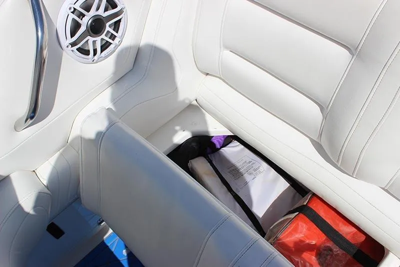 Slide: The Image of Storage compartment in a 2000 Fountain 32 Fever boat with white seating and speaker. - 32