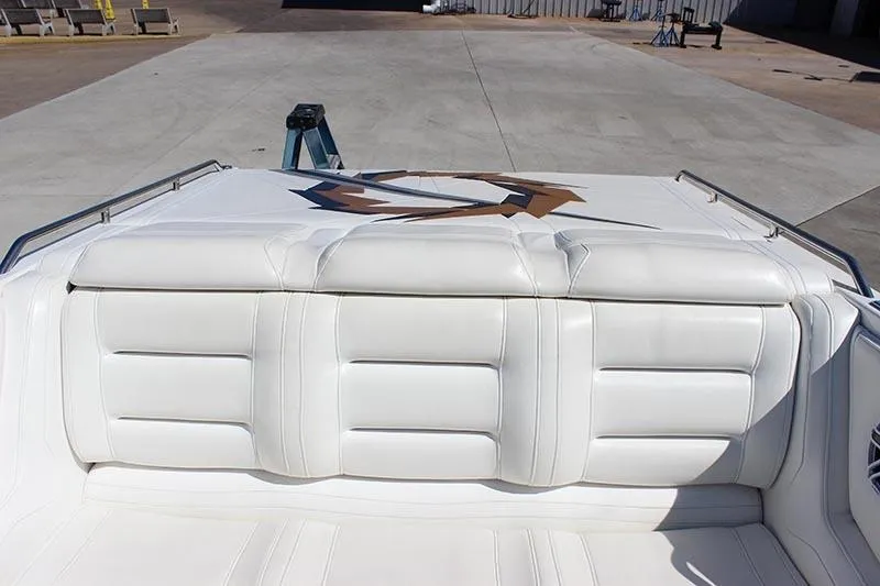 Slide: The Image of White leather seating on a 2000 Fountain 32 Fever boat, docked on concrete. - 33
