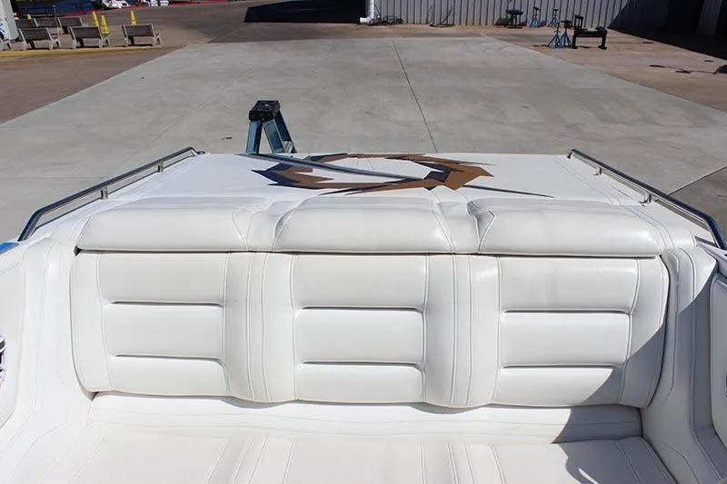 Slide: The Image of 2000 Fountain 32 Fever boat with white cushioned seating, docked on concrete. - 35