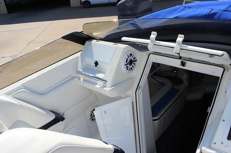 Slide: The Image of Interior view of a 2000 Fountain 32 Fever boat, featuring white seating and cabin access. - 45