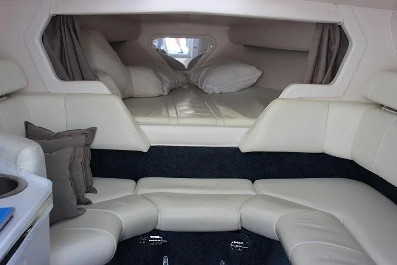 Slide: The Image of Interior cabin of a 2000 Fountain 32 Fever boat with white leather seating. - 47