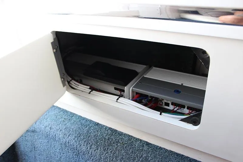 Slide: The Image of Open compartment in 2000 Fountain 32 Fever boat showing electronic equipment and wiring. - 51