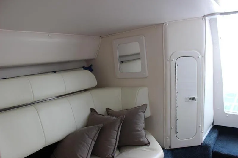 Slide: The Image of Interior of 2000 Fountain 32 Fever boat with white seating and pillows. - 53