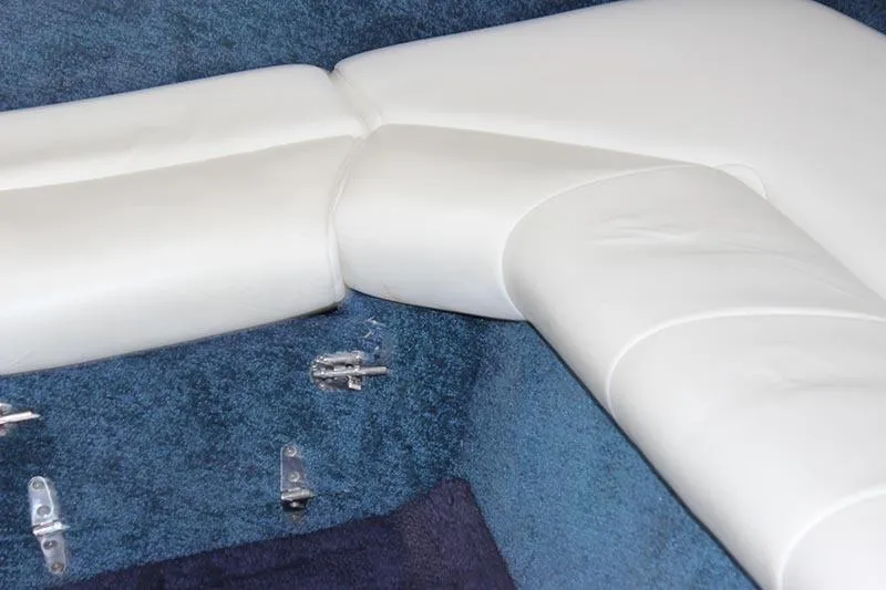 Slide: The Image of White leather seating on blue carpet in 2000 Fountain 32 Fever boat interior. - 54