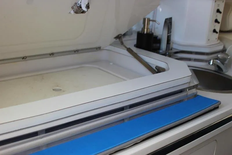 Slide: The Image of Open storage compartment on 2000 Fountain 32 Fever boat, featuring sleek interior design. - 59