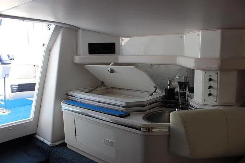 Slide: The Image of Interior of 2000 Fountain 32 Fever boat with kitchenette and seating area. - 60