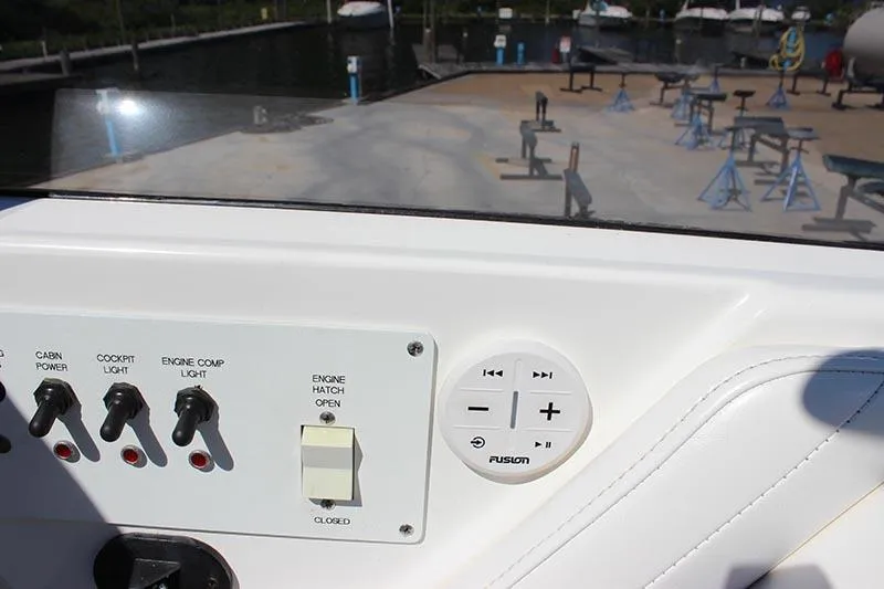 Slide: The Image of Control panel of a 2000 Fountain 32 Fever boat with switches and audio controls. - 7