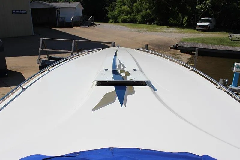 Slide: The Image of 2000 Fountain 32 Fever boat with sleek design and bold graphics at a dock. - 8