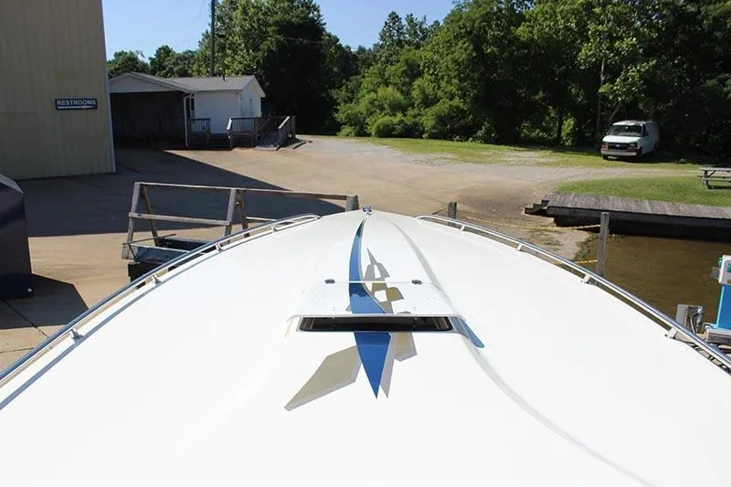 Slide: The Image of 2000 Fountain 32 Fever boat docked near a marina with trees and buildings. - 9