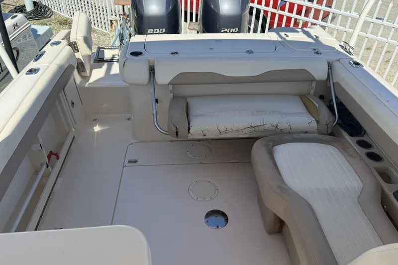 Slide: The Image of 2014 Grady-White Freedom 275 boat interior with seating and twin 200 engines. - 10