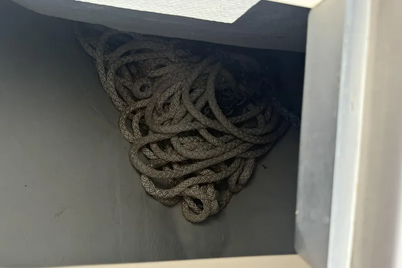 Slide: The Image of Coiled rope stored in a compartment of a 2014 Grady-White Freedom 275 boat. - 29