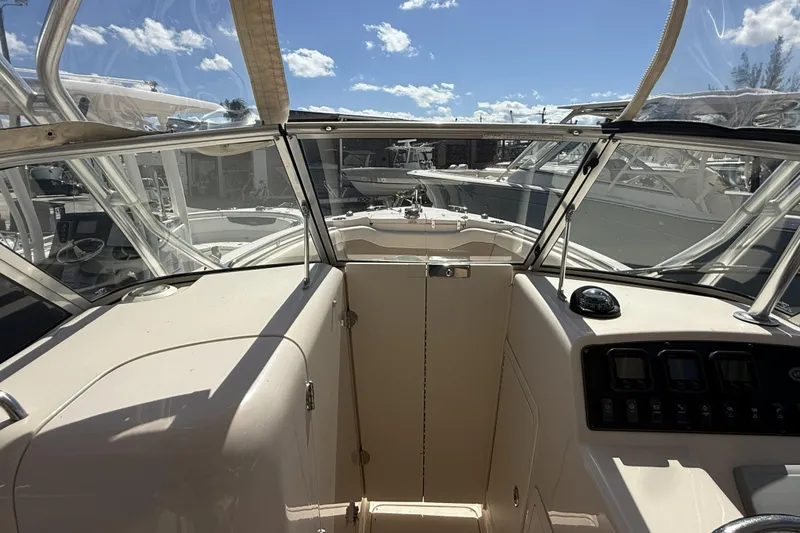 Slide: The Image of 2014 Grady-White Freedom 275 boat interior with clear skies and marina view. - 31