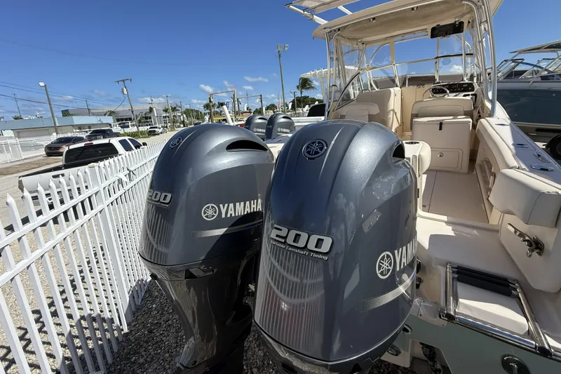 Slide: The Image of 2014 Grady-White Freedom 275 boat with twin Yamaha 200 engines, docked outdoors. - 35