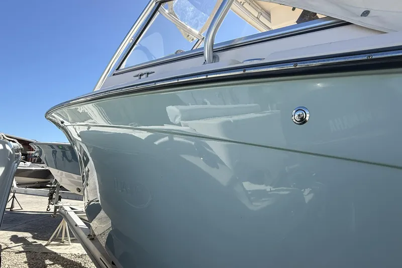 Slide: The Image of 2014 Grady-White Freedom 275 boat, side view under clear blue sky. - 39