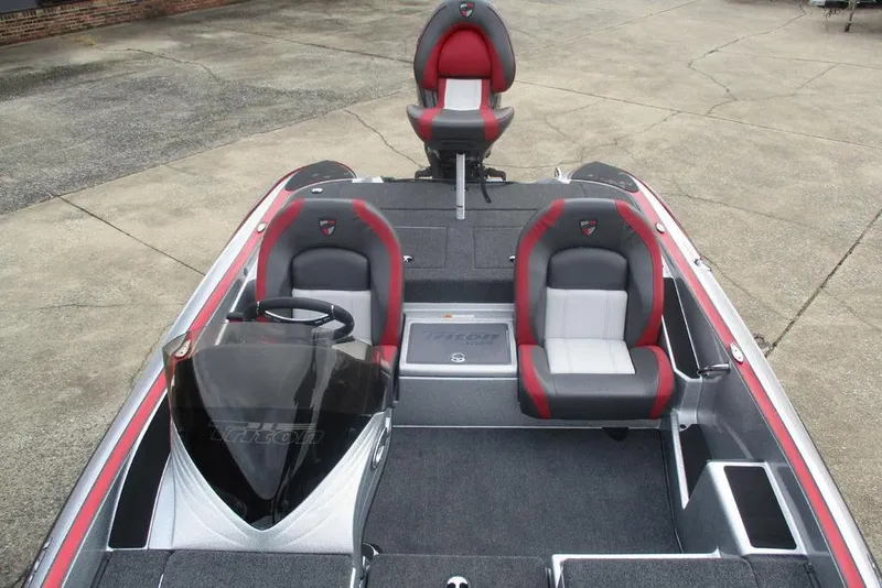 Slide: The Image of 2026 Triton 179 TrX boat interior with red and gray seating, steering console, and spacious deck. - 10