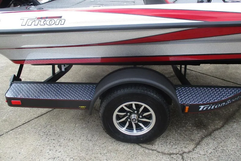 Slide: The Image of 2026 Triton 179 TrX boat trailer with diamond plate step and stylish wheel design. - 11