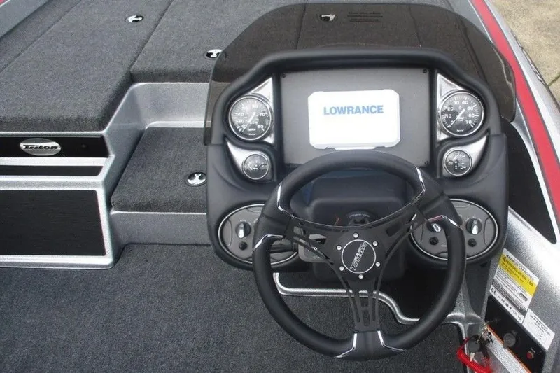 Slide: The Image of 2026 Triton 179 TrX boat dashboard with Lowrance display and steering wheel. - 5