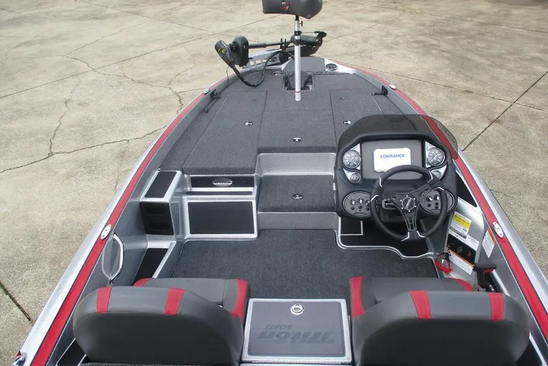 Slide: The Image of 2026 Triton 179 TrX boat interior with steering console and seating. - 8