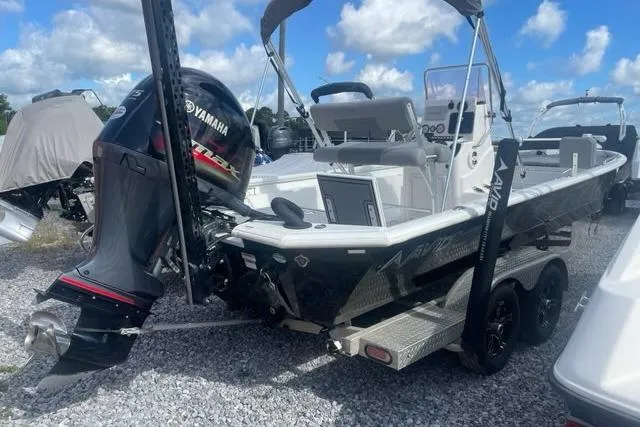 Slide: The Image of 2021 Avid 23 Fusion boat with Yamaha outboard motor on a trailer, parked outdoors. - 3