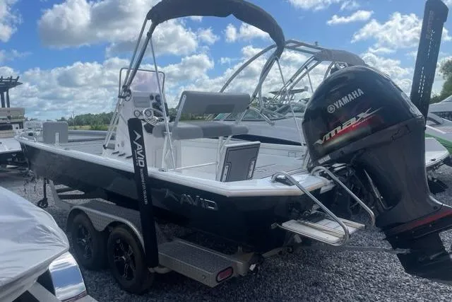 Slide: The Image of 2021 Avid 23 Fusion boat with Yamaha outboard motor on trailer under blue sky. - 4