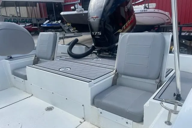 Slide: The Image of 2021 Avid 23 Fusion boat interior with gray seating and powerful 175 HP engine. - 7