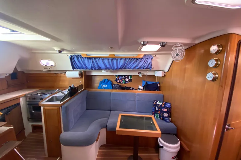 Slide: The Image of Interior of 2006 Catalina 309 sailboat with cozy seating and compact kitchen area. - 11